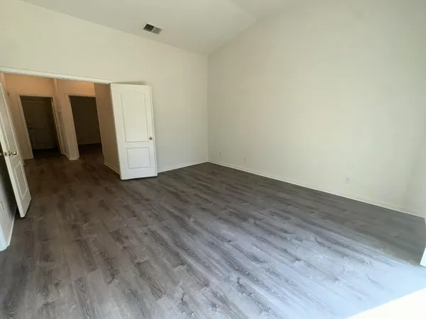 a view of an empty room with closet