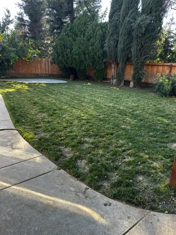 a backyard of a house with lots of green space