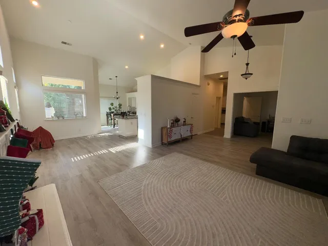 a bedroom with furniture and a ceiling fan