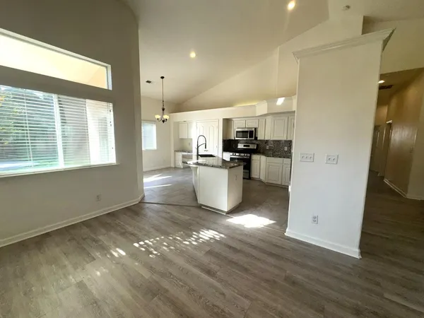 a kitchen with refrigerator and window
