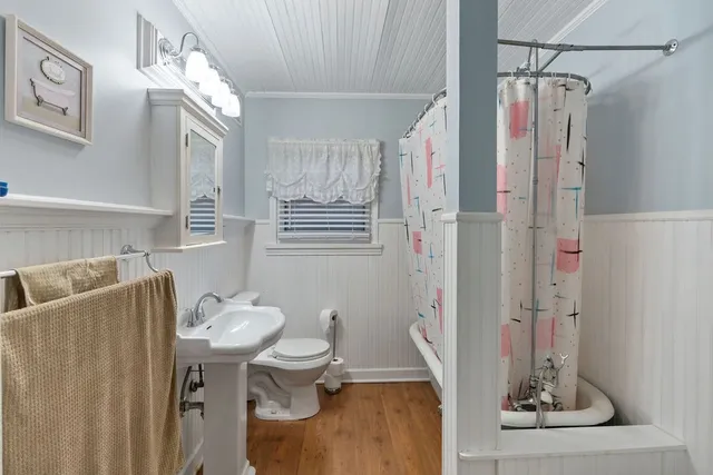 a bathroom with a sink a toilet and mirror