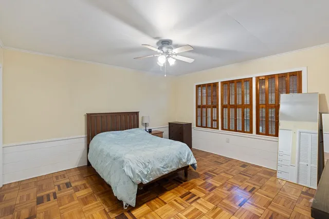 a bedroom with a large bed and a chandelier