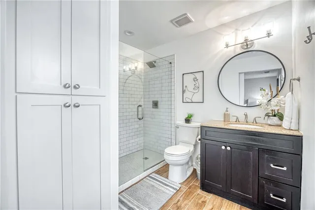 a bathroom with a toilet a sink and mirror