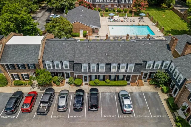 an aerial view of multiple houses with yard