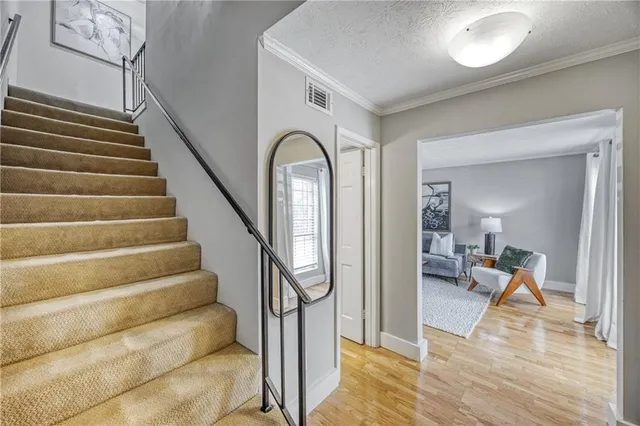 a view of entryway and hall with wooden floor
