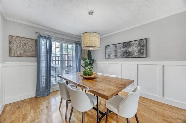 a view of a dining room with furniture window and wooden floor