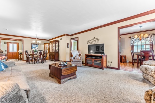 197 Mathews Road, Unit A Youngstown, OH 44512 - Photo 8 of 32 Living room with an inviting chandelier, crown molding, and light colored carpet