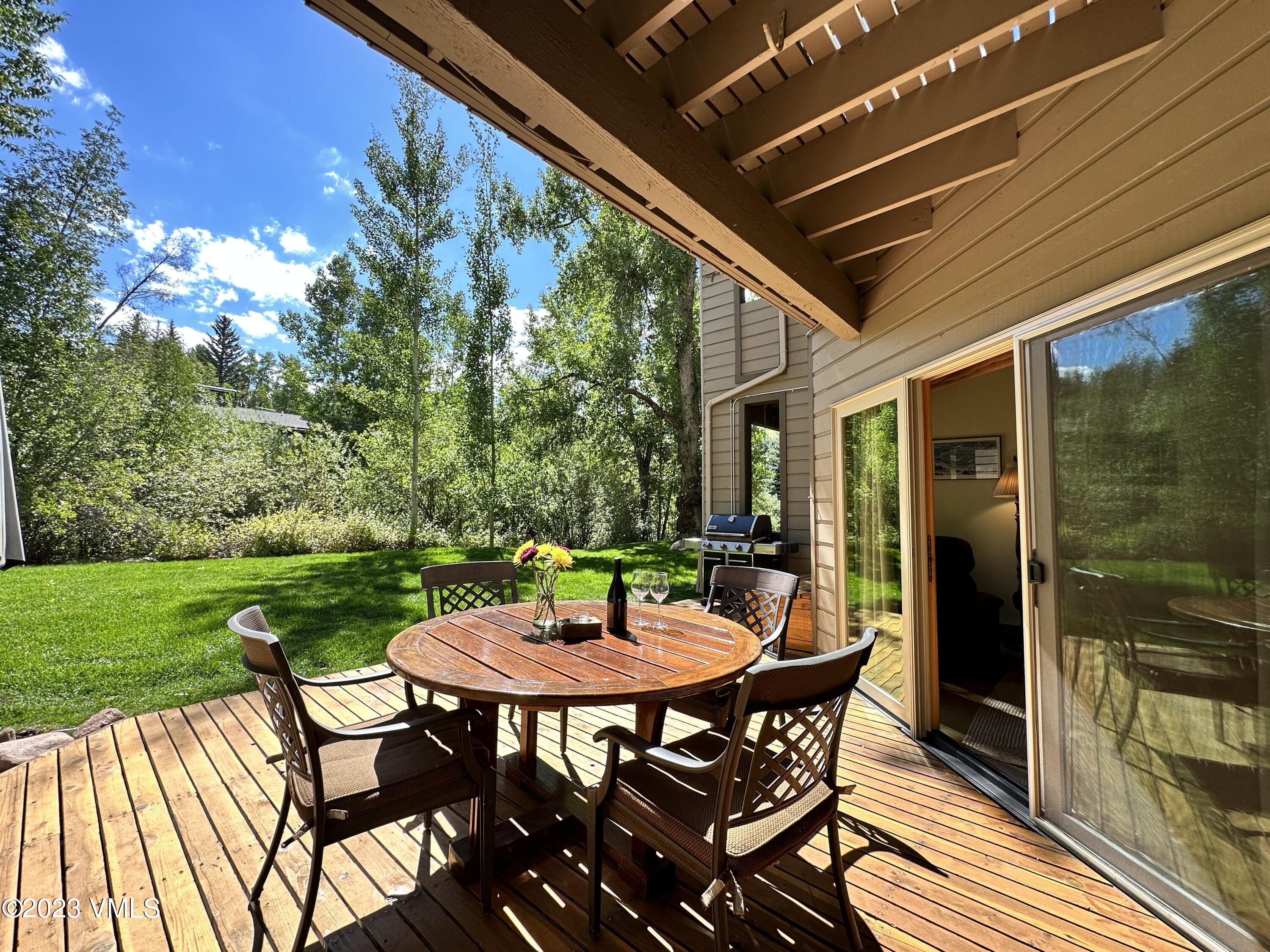 945 Red Sandstone Road, Unit B3 Vail, CO 81657 - Photo 29 of 48 a table and chairs in front of a house