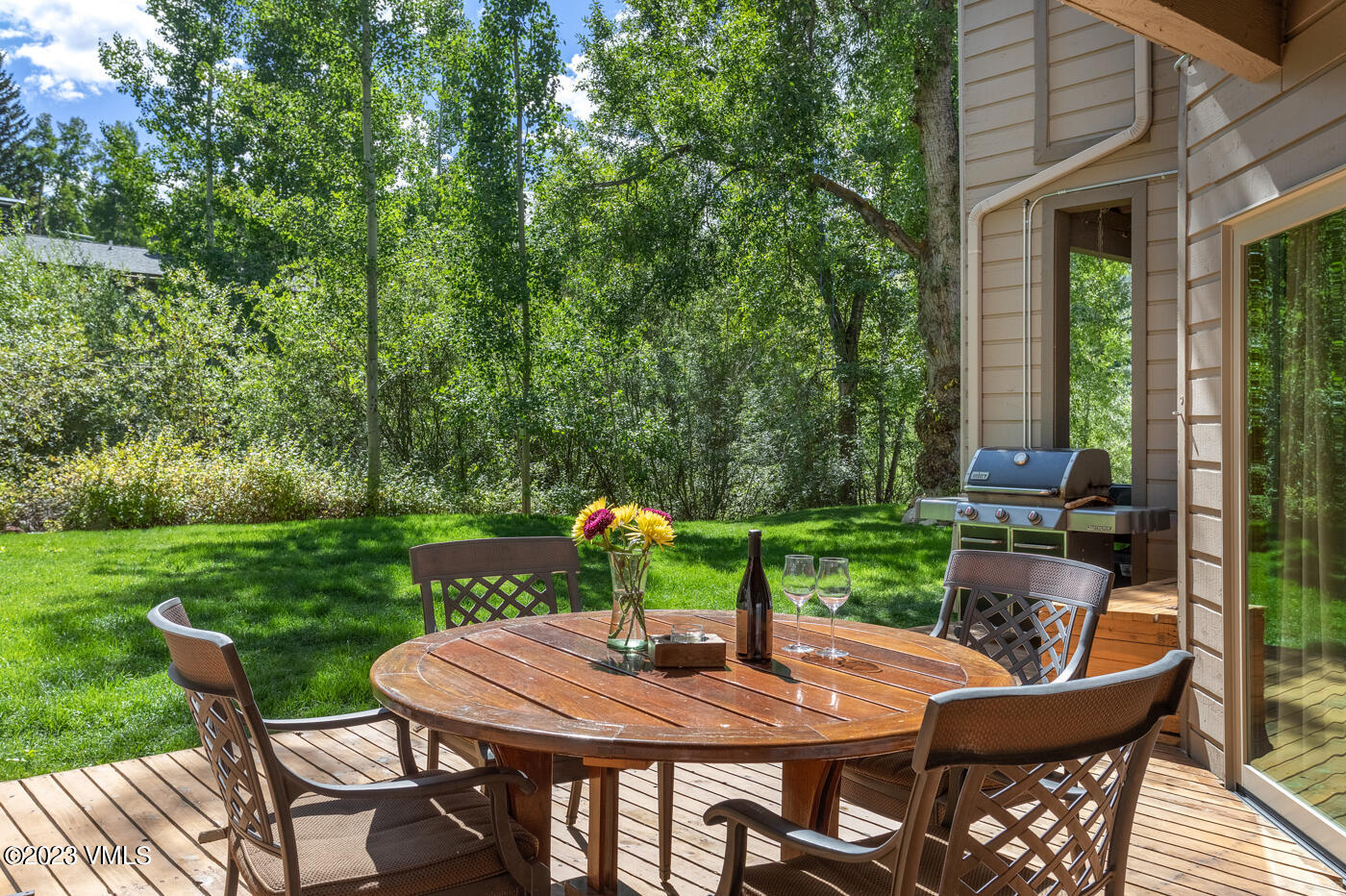 945 Red Sandstone Road, Unit B3 Vail, CO 81657 - Photo 36 of 48 a view of a patio with a table chairs and a backyard