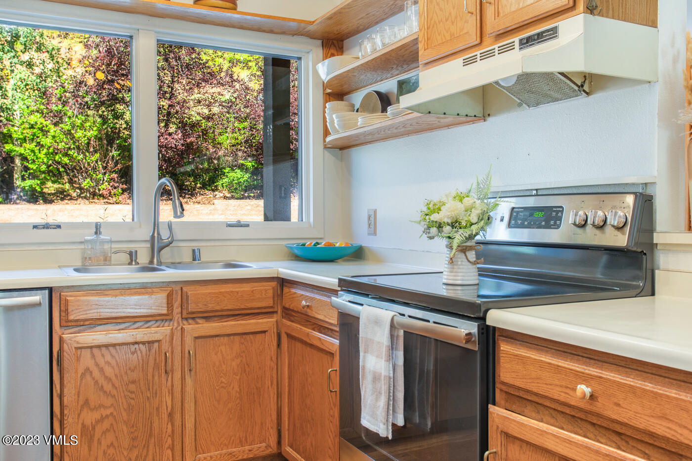 945 Red Sandstone Road, Unit B3 Vail, CO 81657 - Photo 5 of 48 a kitchen with stainless steel appliances granite countertop a sink and a window