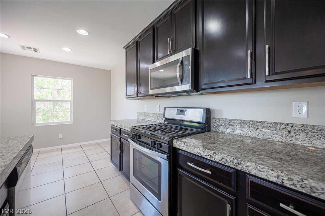 9916 Sable Point Street Las Vegas, NV 89178 - Photo 38 of 73 Culinary delights await in this sleek kitchen featuring granite countertops and contemporary appliances.