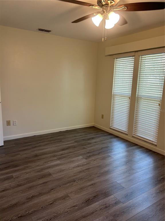 2935 Plantation Road Winter Haven, FL 33884 - Photo 11 of 32 a view of an empty room with wooden floor and fan