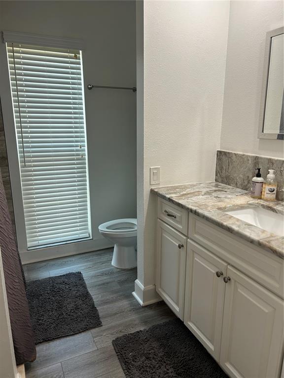 2935 Plantation Road Winter Haven, FL 33884 - Photo 14 of 32 a bathroom with a granite countertop sink toilet a mirror and vanity