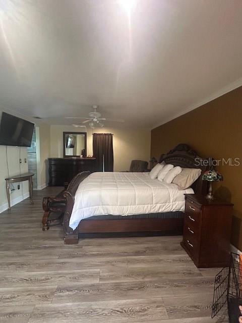 2935 Plantation Road Winter Haven, FL 33884 - Photo 19 of 32 a bedroom with a bed and wooden floor