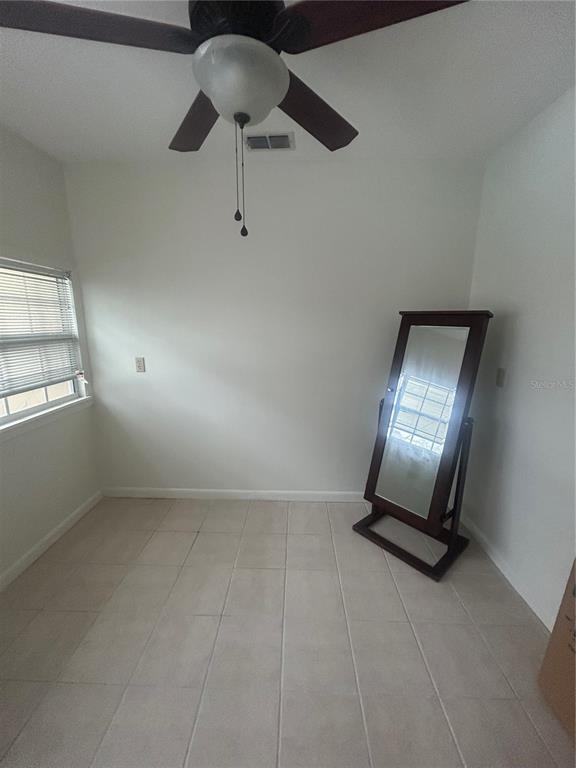 2935 Plantation Road Winter Haven, FL 33884 - Photo 24 of 32 an empty room with chandelier fan and windows