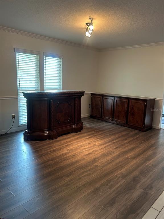 2935 Plantation Road Winter Haven, FL 33884 - Photo 4 of 32 an empty room with wooden floor and windows