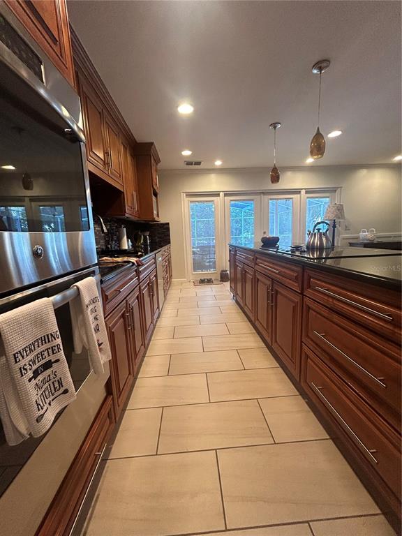 2935 Plantation Road Winter Haven, FL 33884 - Photo 7 of 32 a large kitchen with stainless steel appliances lots of counter space and breakfast area