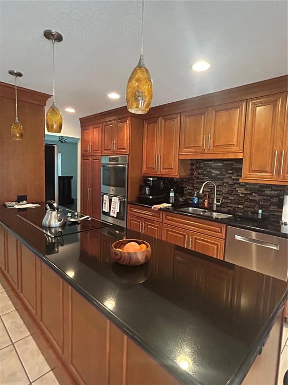 2935 Plantation Road Winter Haven, FL 33884 - Photo 8 of 32 a kitchen with stainless steel appliances a sink a stove and a wooden floor