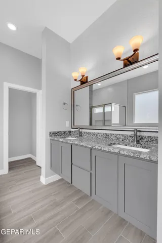 a bathroom with a glass shower door