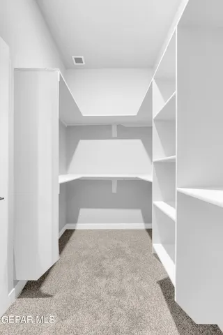 a kitchen with granite countertop white cabinets and a sink