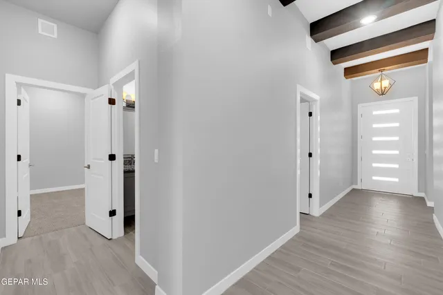 an empty room with a ceiling fan and window