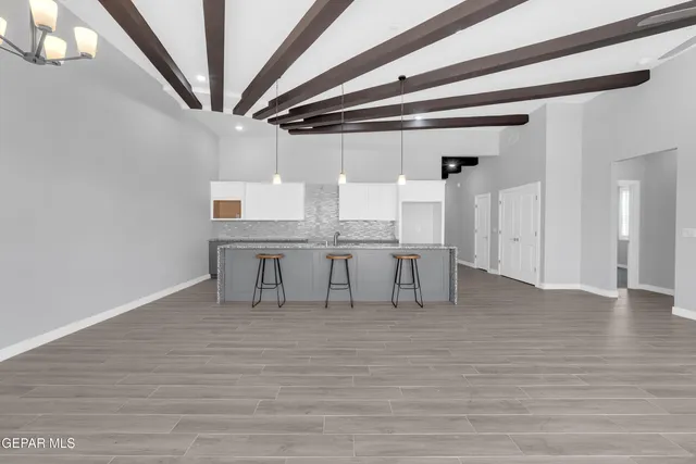 a kitchen with granite countertop white cabinets and a sink