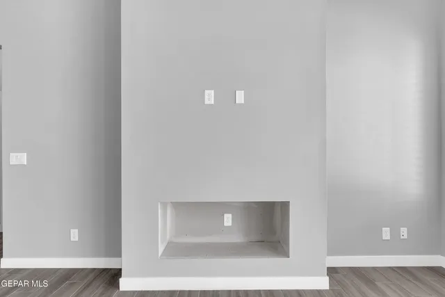 an empty room with closet area with fan