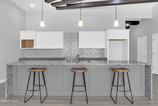 a bathroom with a granite countertop bathtub shower sink and mirror
