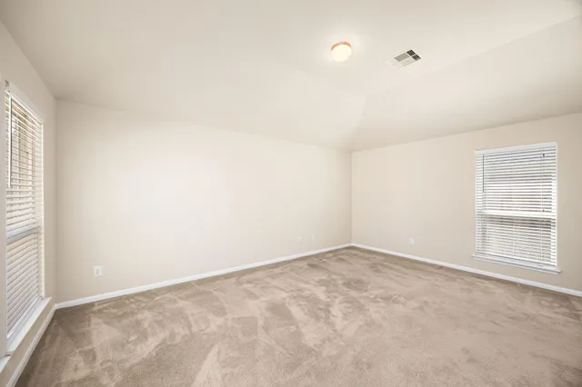 an empty room with windows and closet