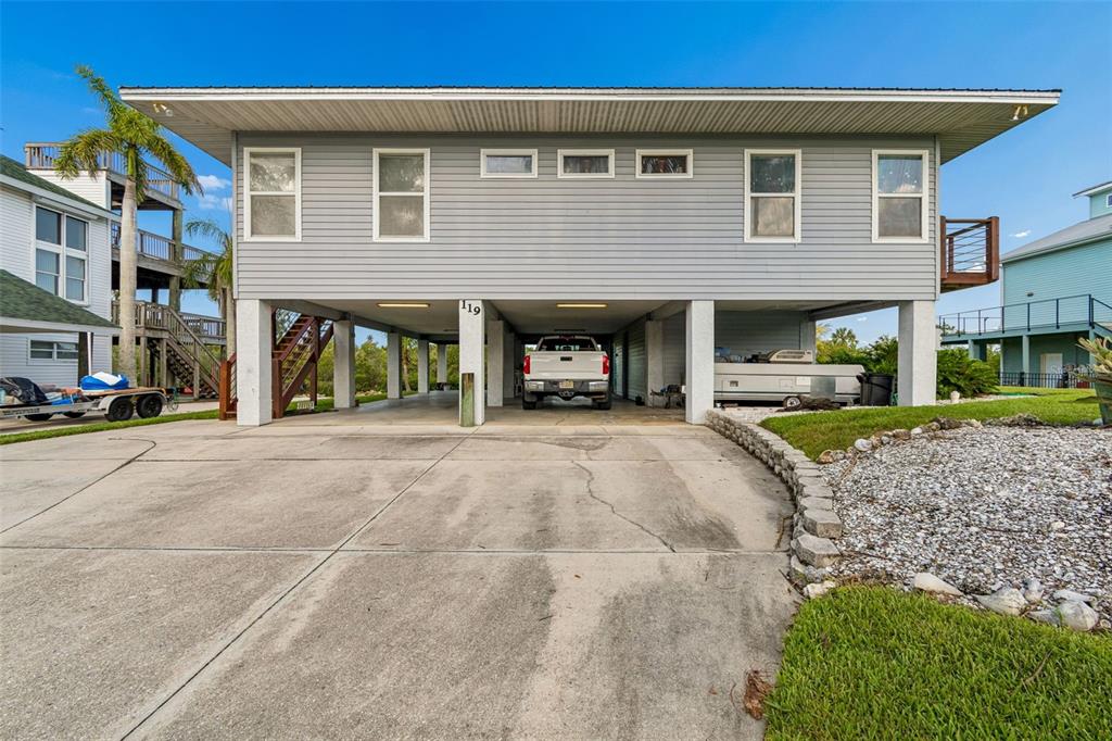 119 Burns Road Terra Ceia, FL 34250 - Photo 4 of 100 a front view of a house with a yard and a garage
