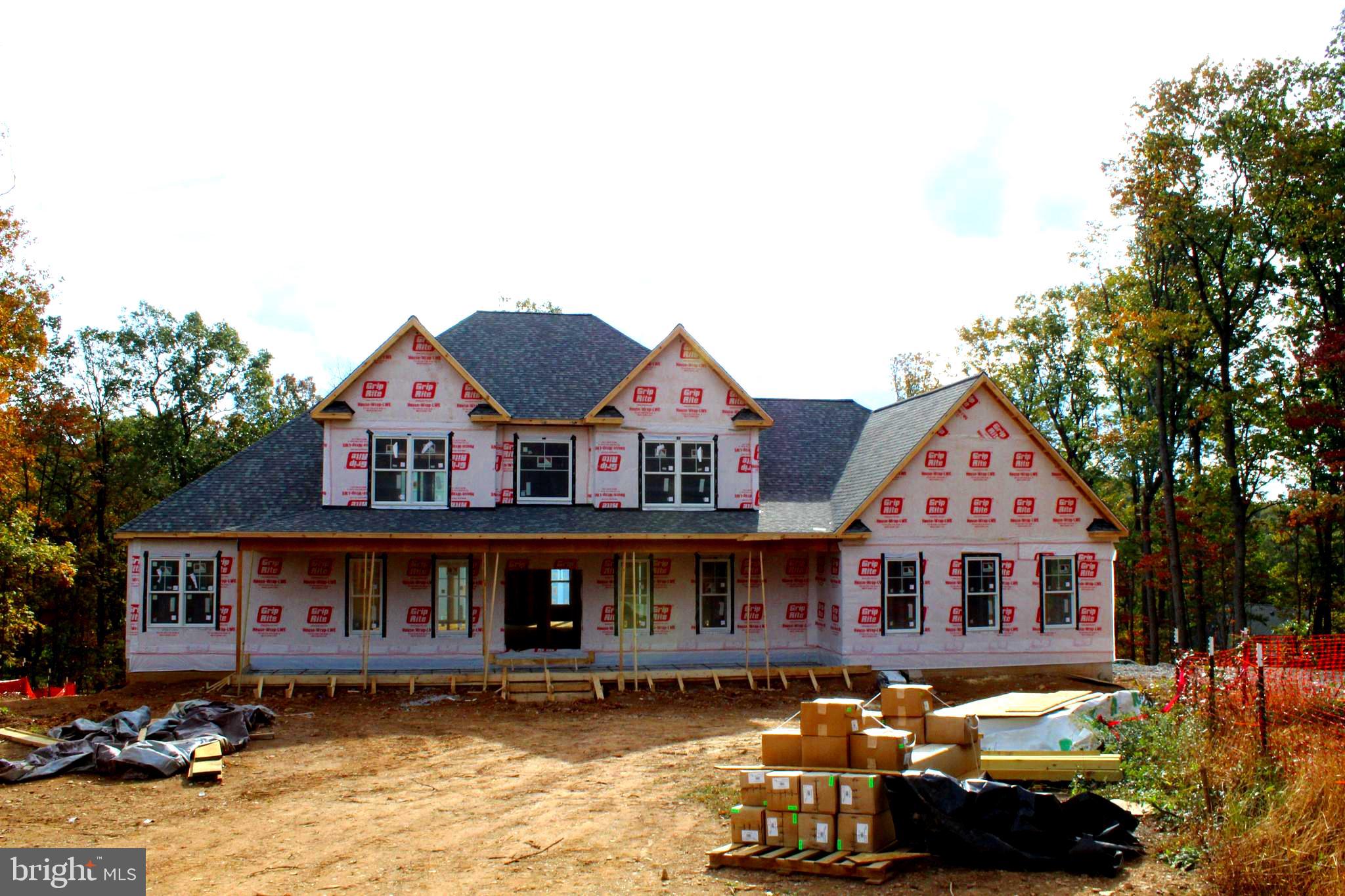 a front view of a house with yard and balcony