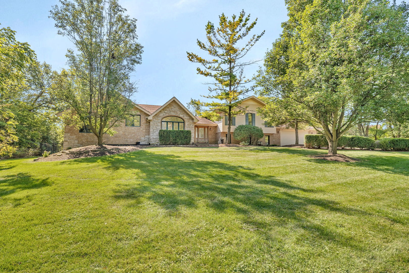 9417 West Steger Road Frankfort, IL 60423 - Photo 1 of 52 a yellow house with trees in front of it