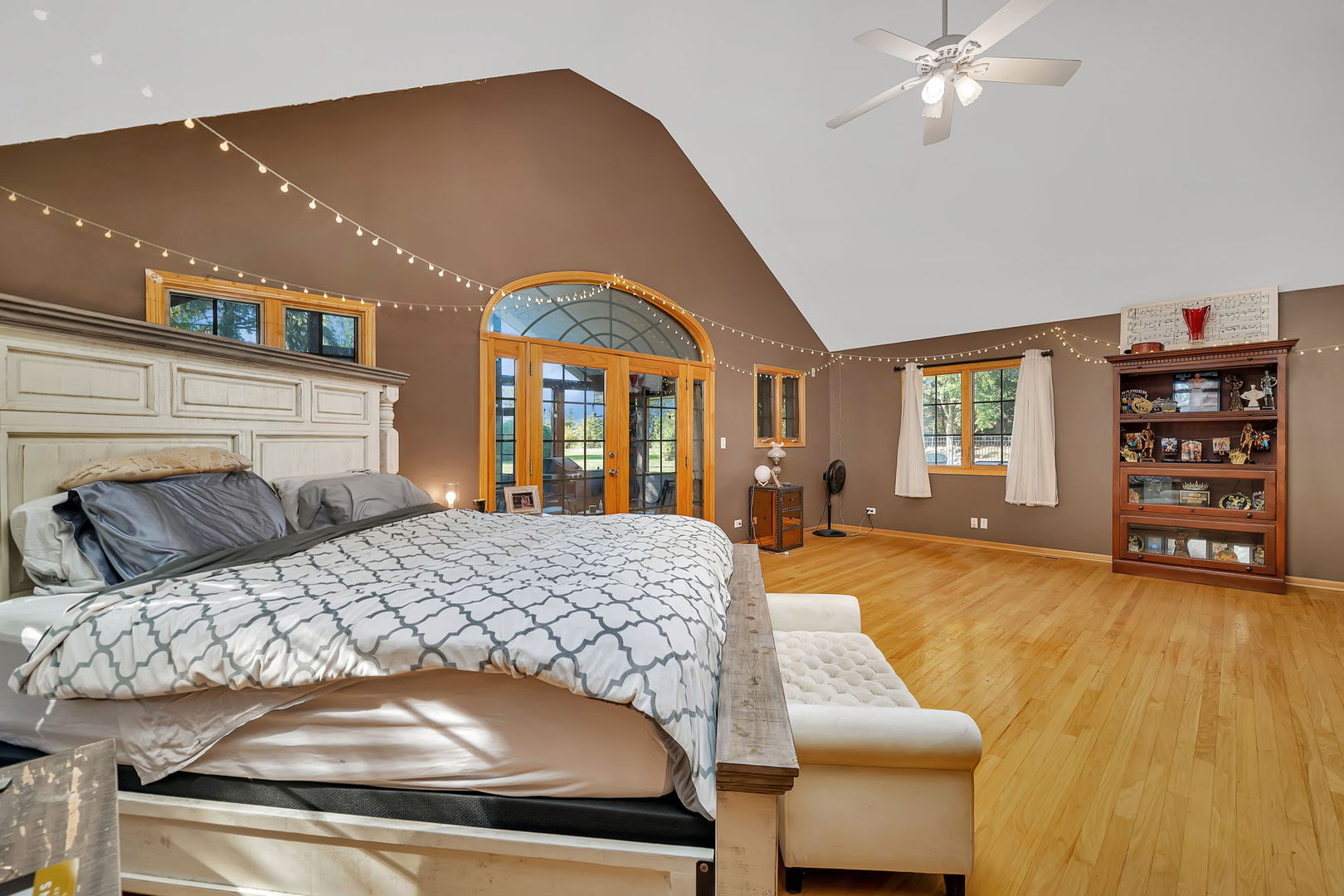 9417 West Steger Road Frankfort, IL 60423 - Photo 14 of 52 a bedroom with a large bed and a chandelier