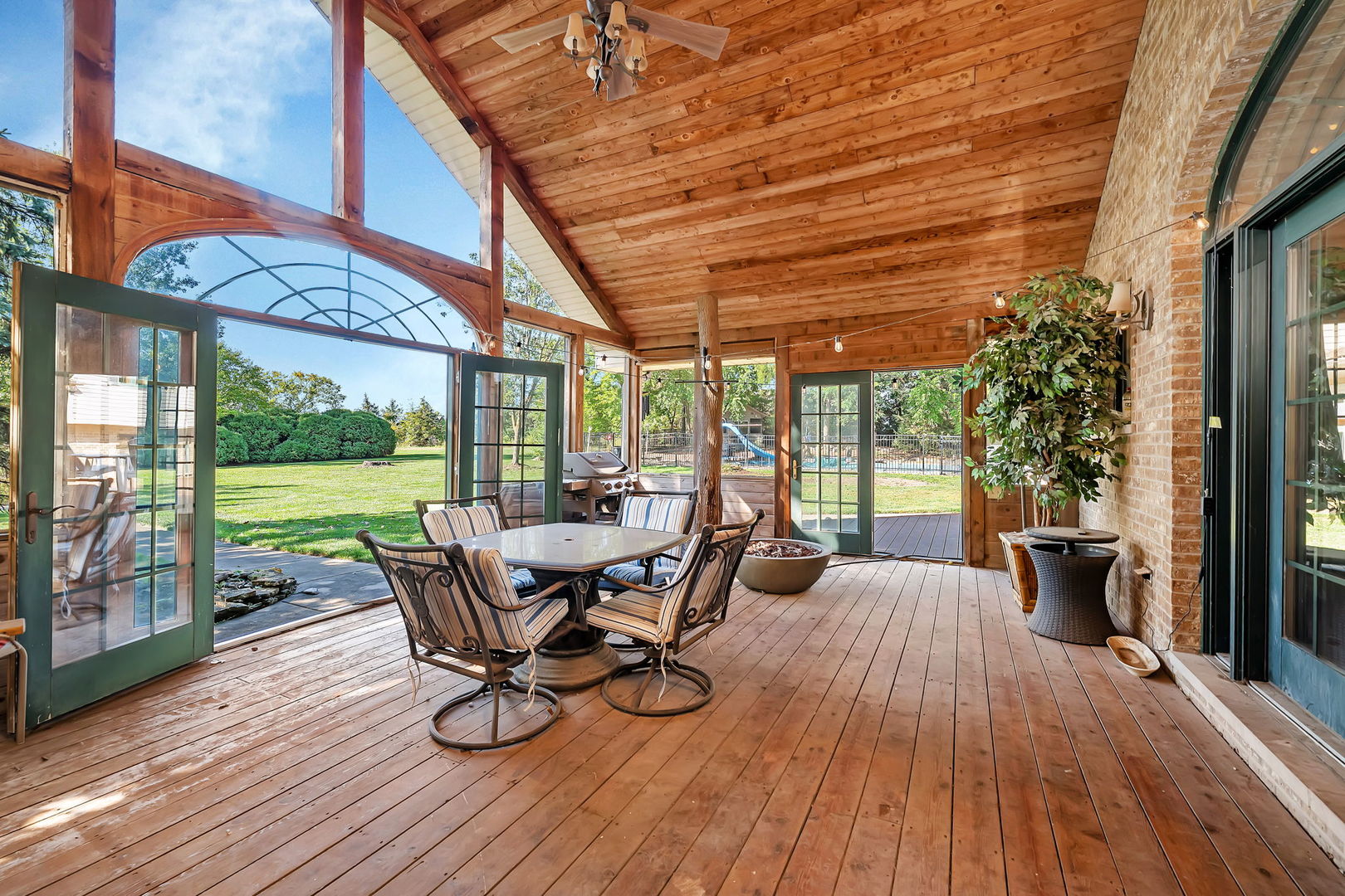 9417 West Steger Road Frankfort, IL 60423 - Photo 16 of 52 a view of a patio with table and chairs potted plants with wooden floor