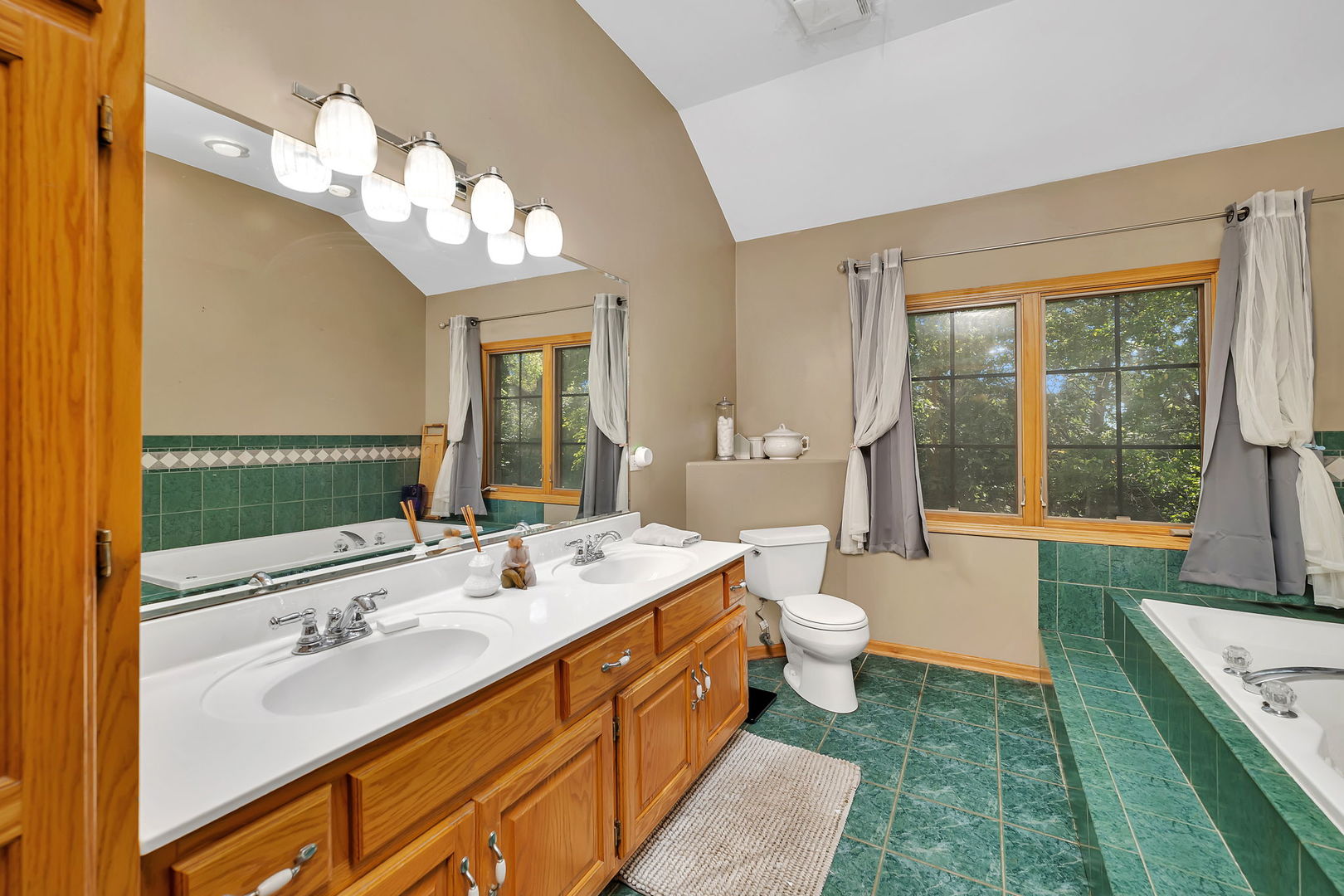 9417 West Steger Road Frankfort, IL 60423 - Photo 18 of 52 a spacious bathroom with a double vanity sink a large mirror and a toilet