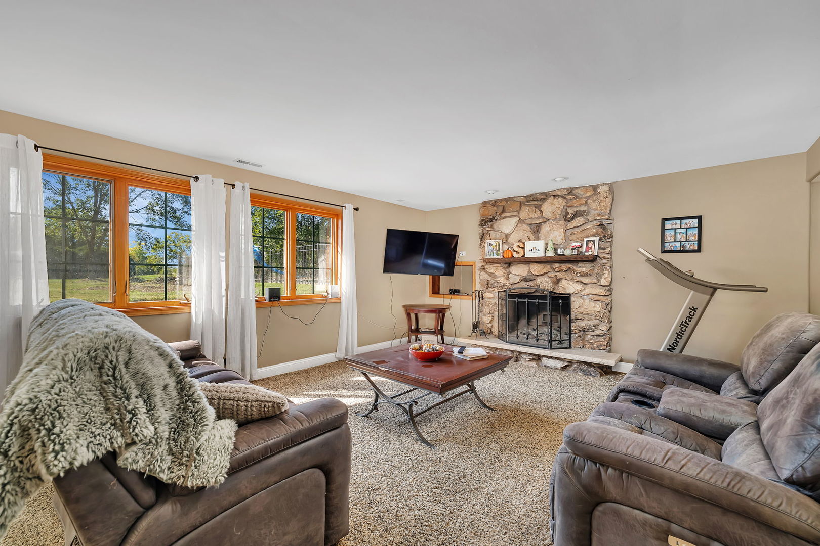 9417 West Steger Road Frankfort, IL 60423 - Photo 25 of 52 a living room with furniture a fireplace and a large window