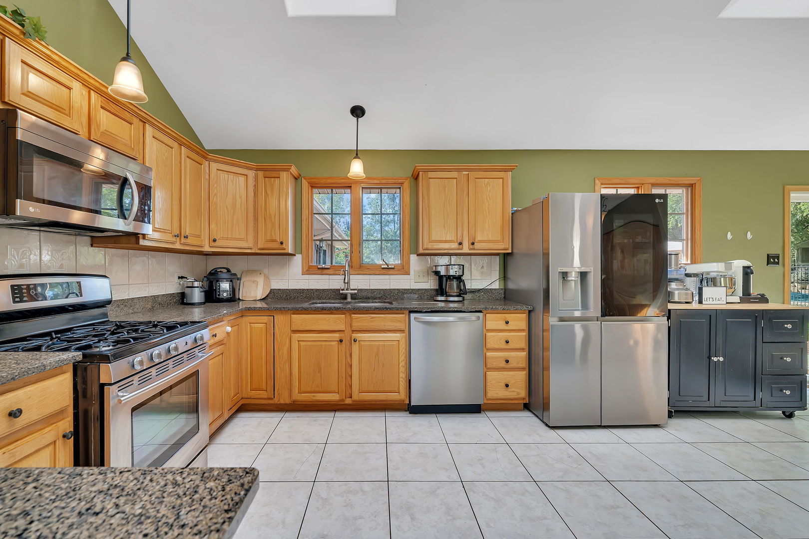 9417 West Steger Road Frankfort, IL 60423 - Photo 5 of 52 a kitchen with stainless steel appliances granite countertop a stove a sink and a refrigerator