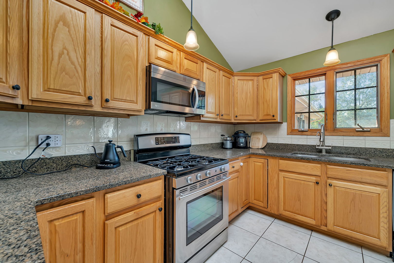 9417 West Steger Road Frankfort, IL 60423 - Photo 6 of 52 a kitchen with stainless steel appliances granite countertop a sink a stove and cabinets