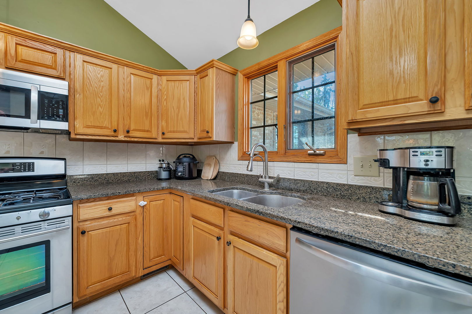 9417 West Steger Road Frankfort, IL 60423 - Photo 7 of 52 a kitchen with stainless steel appliances granite countertop a sink and cabinets