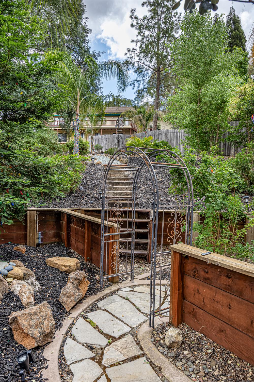 2083 State Rte 26 Valley Springs, CA 95252 - Photo 38 of 59 a view of a patio with table and chairs with wooden fence and plants