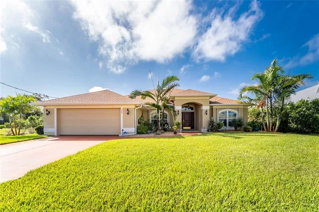 a front view of a house with yard and garage