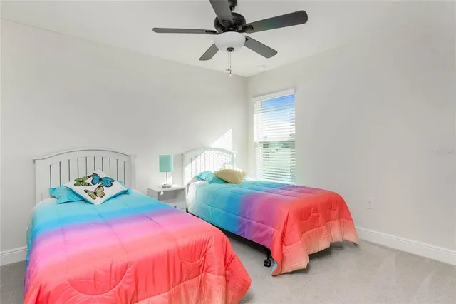 a bedroom with two beds and a chandelier