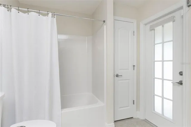 a bathroom with a shower and a toilet