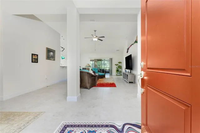 a view of livingroom with furniture and a kitchen