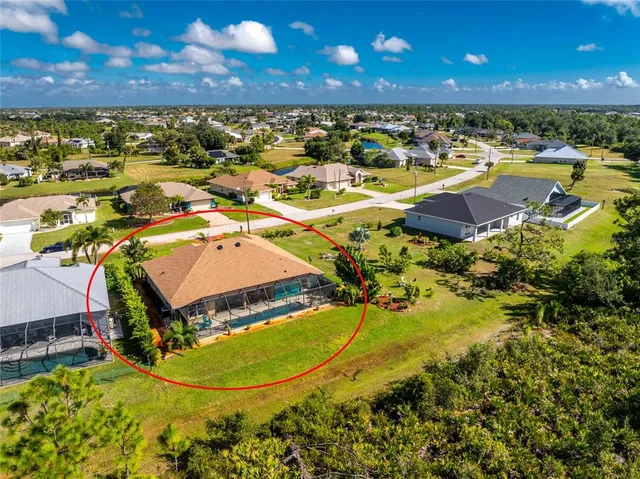 an aerial view of residential houses with outdoor space