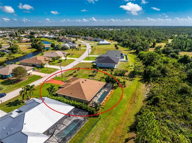 an aerial view of residential houses with outdoor space