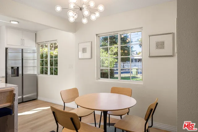 a view of a dining room with furniture and a window