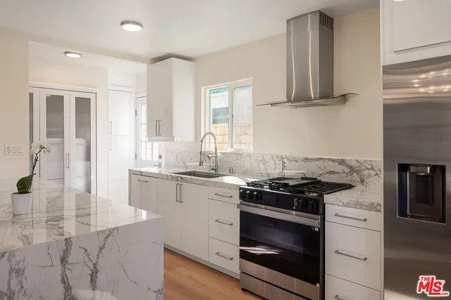 a kitchen with stainless steel appliances granite countertop a stove and a sink
