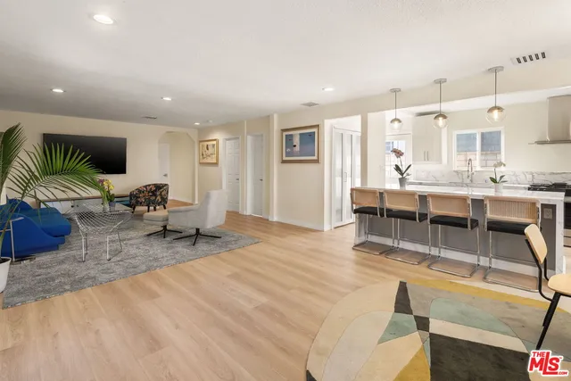 a living room with kitchen island furniture and a table