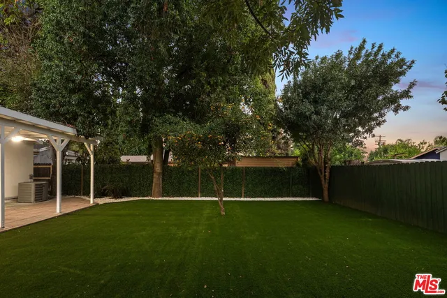 a view of a park with large trees